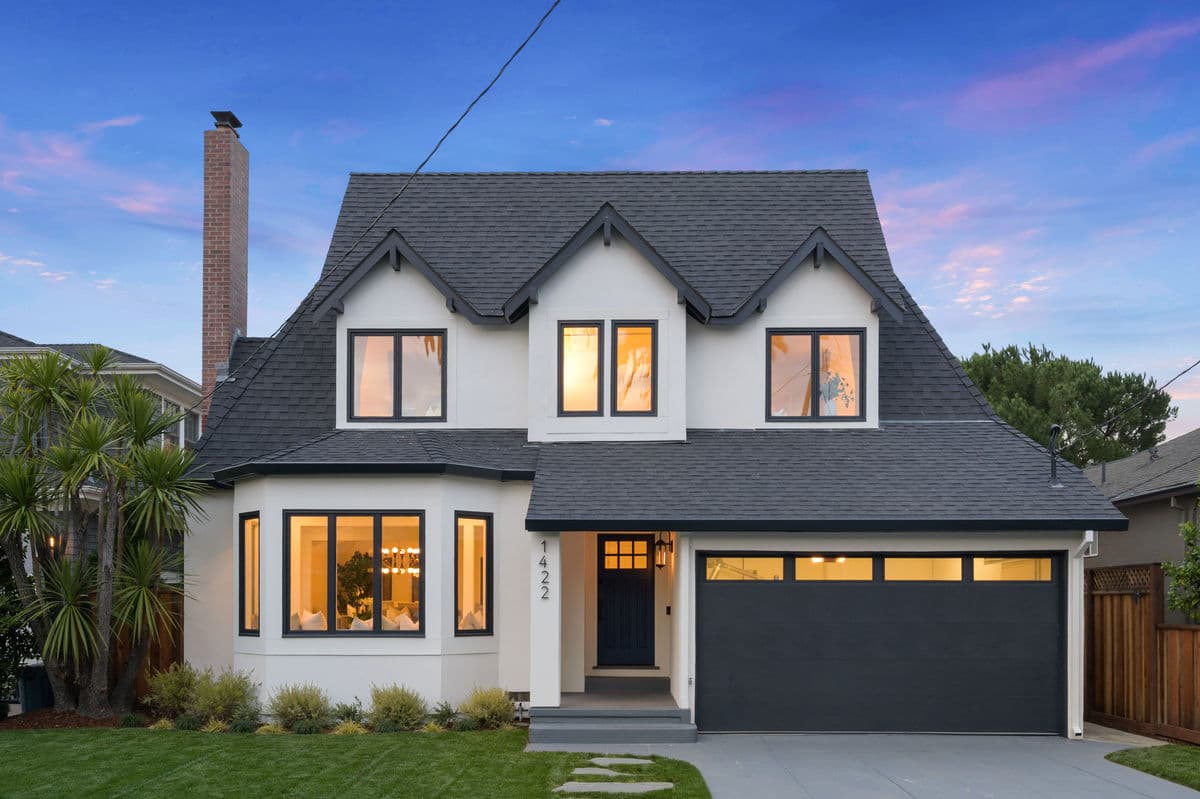 White Tudor-style home exterior painting